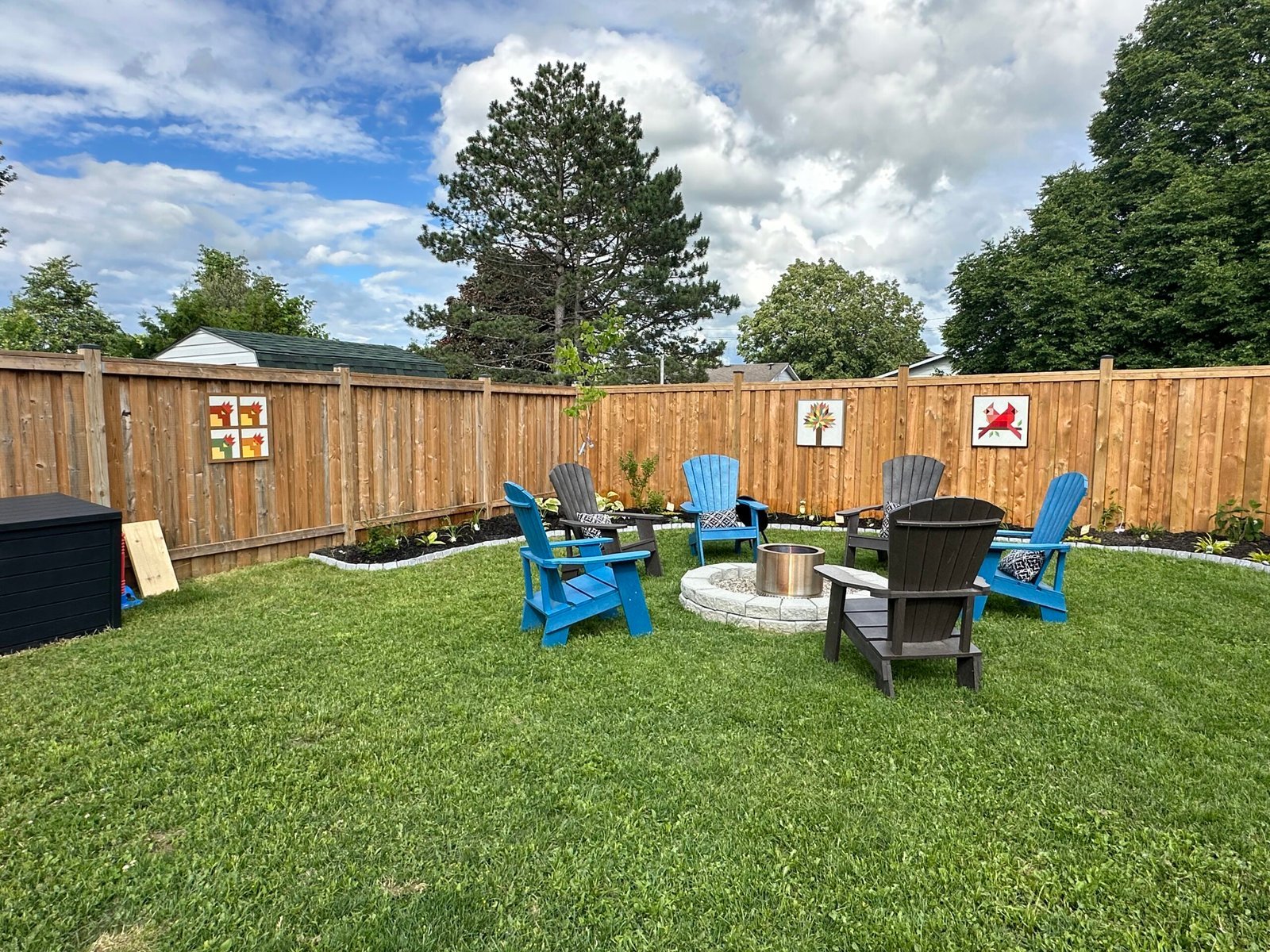 Backyard with fire pit and Muskoka chairs